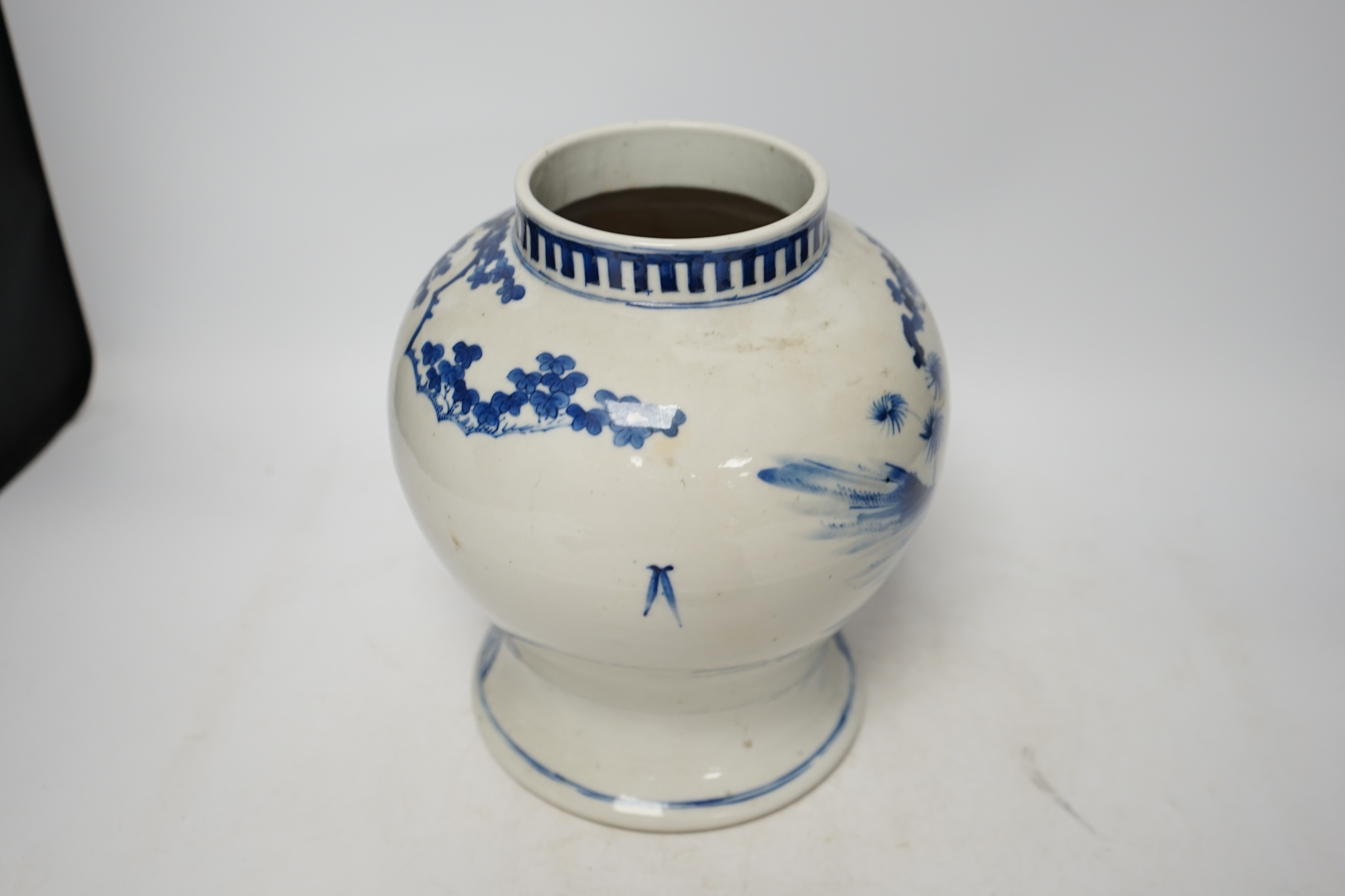 A 19th century Chinese blue and white baluster jar, painted with a dignitary and attendants at a table with objects in a garden setting, wood cover, 35cm. Condition - good